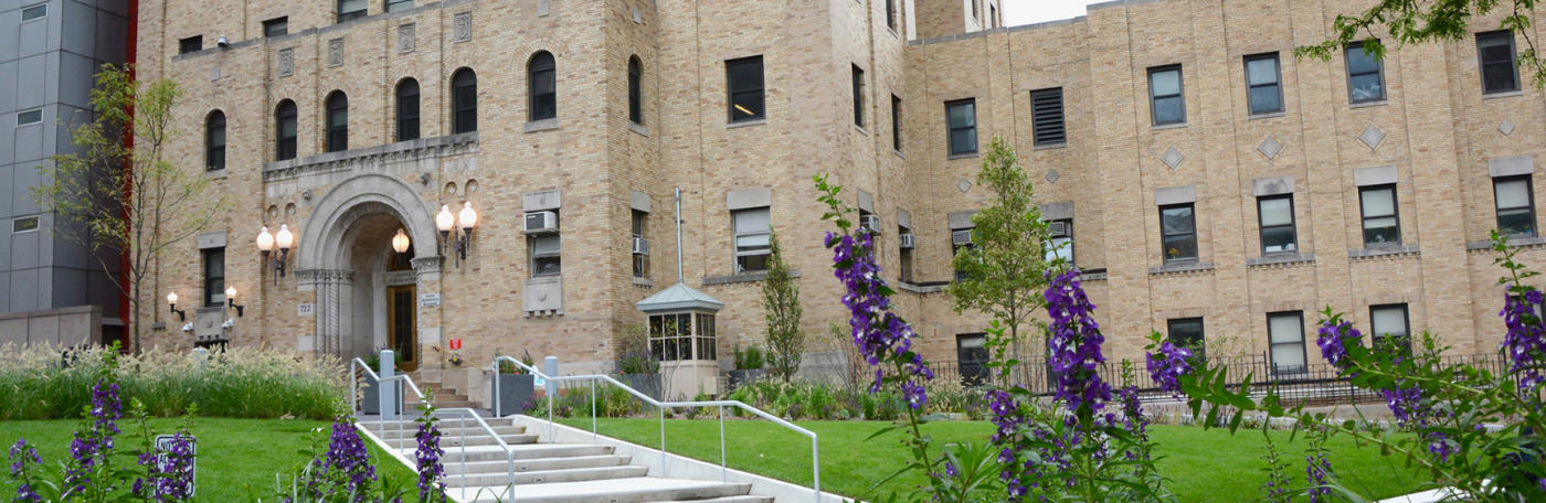Image of building with purple flowers